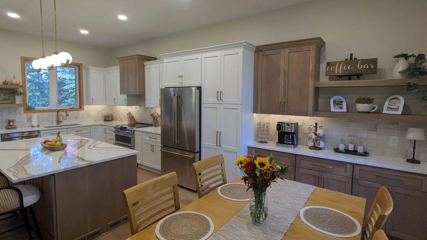 Kitchen with white and wood cabinetry and a large island in Woodbury MN