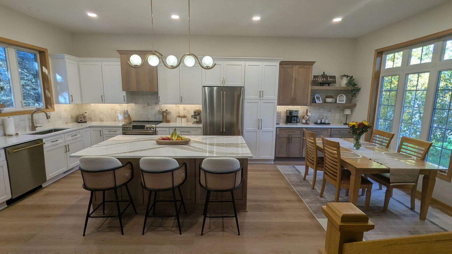 Kitchen with white cabinets and a large marble island in Woodbury MN